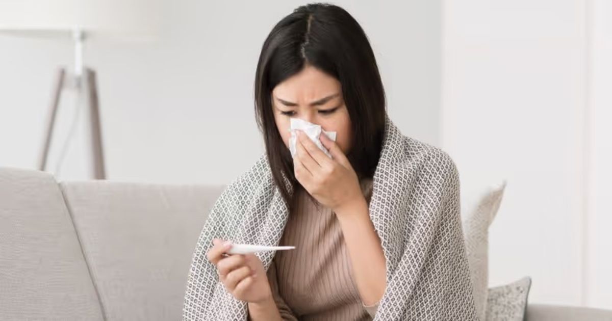An Asian woman takes an ATK test to check if she is infected with COVID-19