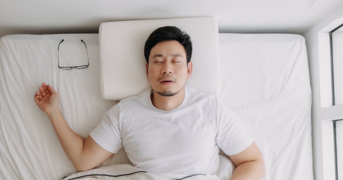 An Asian man sleeps and dies from sudden unexplained nocturnal death syndrome (SUNDS) with an unknown cause and without any warning signs or symptoms. 